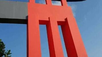 A red structural element, possibly part of a building's facade.
