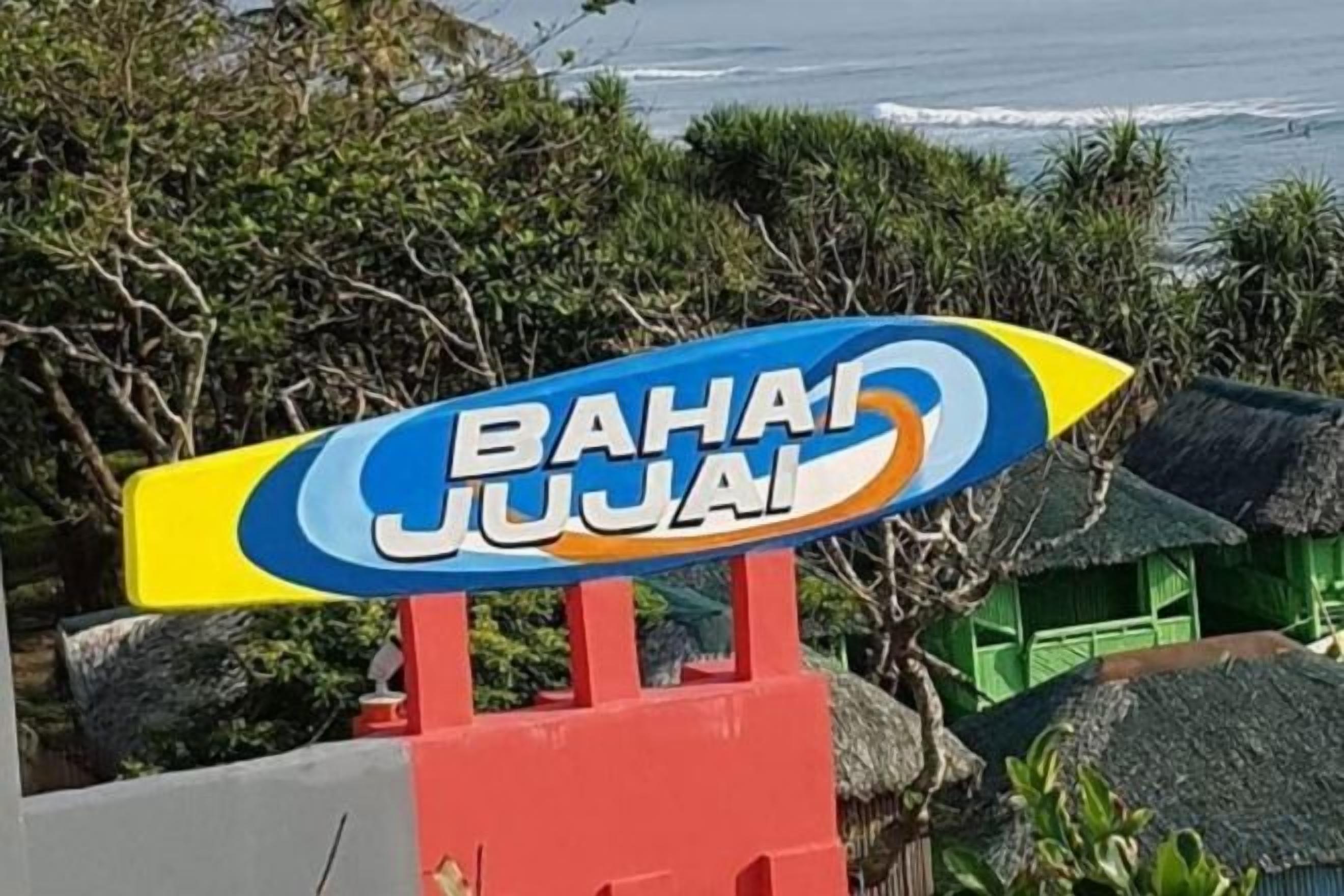 A sign with the text 'BAHA JUJAI' on a colorful background.