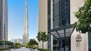 A modern building with a glass facade and a sign that reads "ACLIK". - bnbme Luxury Apt Pool w/ Burj Khalifa Views (Dubai)