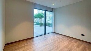 A spacious room with a large sliding glass door leading to an outdoor area. - bnbme Luxury Apt Pool w/ Burj Khalifa Views (Dubai)