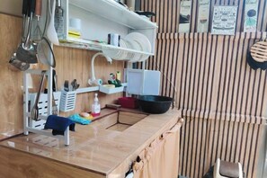 A kitchen with a sink, a stove, and various utensils. - Home in Pagadian City near airport (Pagadian)