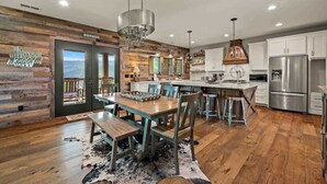 A modern kitchen with wooden accents, stainless steel appliances, and a central island.