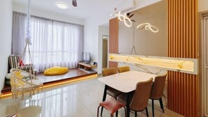 A modern dining area with a table and chairs, a ceiling fan, and a large window with curtains.