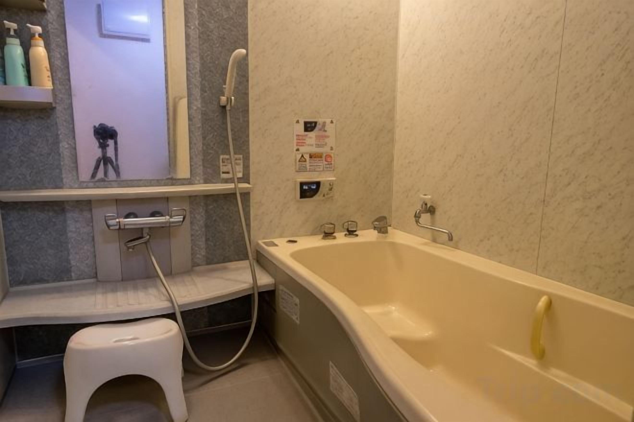 A bathroom with a bathtub, a shower, and a toilet.