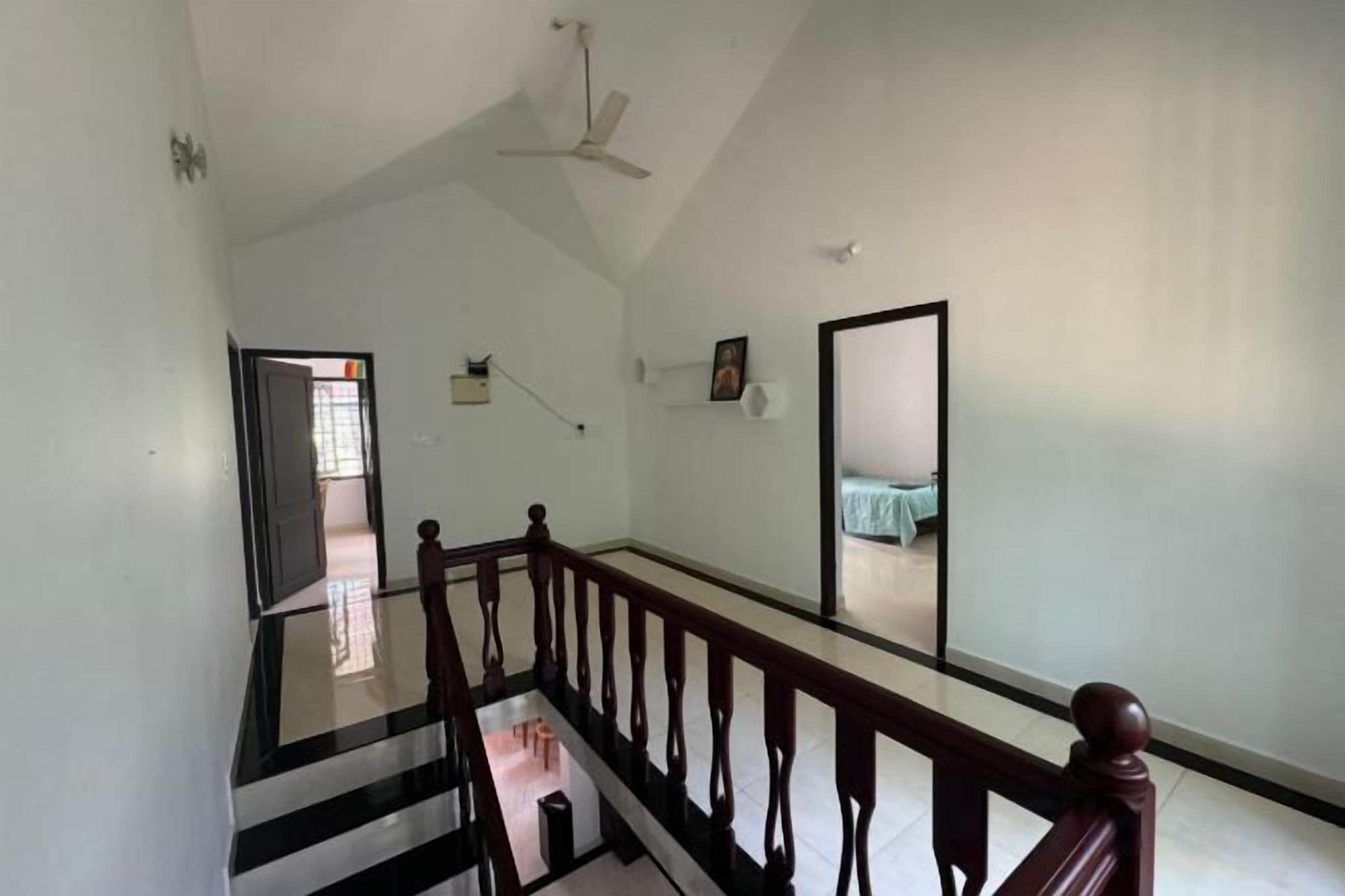 A staircase with a wooden handrail leading to an upper floor.