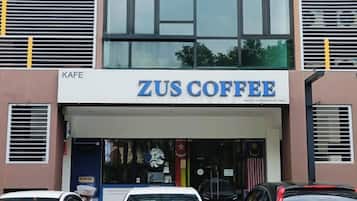 A building with a sign reading 'ZUS COFFEE' and a visible entrance.