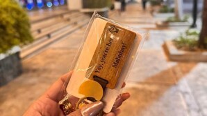 A hand holding a wooden keychain with the text "Yay, you're here! Mabuha!" - Lovely Unit with free wifi & netflix I across Naia Terminal 3 airport (Pasay)