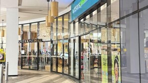 A modern shopping mall interior with a Watsons pharmacy and a store named 'GHTY ONE MALL'. - Lovely Unit with free wifi & netflix I across Naia Terminal 3 airport (Pasay)