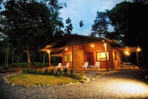 A two-story wooden cabin with a covered porch and outdoor seating area. - Krabi Kabin (Krabi)