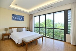 A bedroom with a large bed, bedside tables, and a view through a large window. - Private pool villa - Your home, your resort (Da Nang)