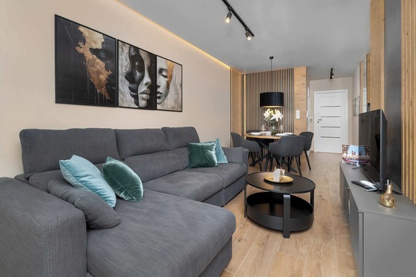 Relax in the stylish living room with a comfortable sofa and modern decor.