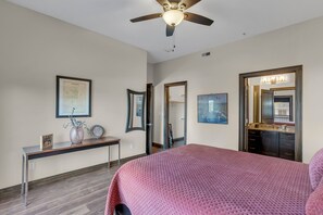 A hotel room with a bed, a desk, a mirror, and a ceiling fan. - Upscale 2-bedroom luxury loft in vibrant downtown Columbia, MO, in The District (Columbia)