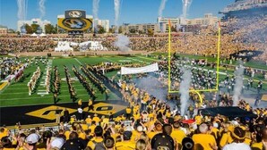 A stadium filled with spectators and a marching band performing on the field. - Upscale 2-bedroom luxury loft in vibrant downtown Columbia, MO, in The District (Columbia)