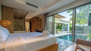 A modern bedroom with a large bed, a glass-enclosed balcony, and a pool view. - Villa Allamanda 3 Bdrm Best Location Bangtao Beach VVPHU88 (Phuket)