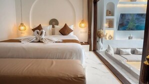 A hotel room with two beds, a large window, and a view of the sea. - Sueño Villa Seminyak (Bali)