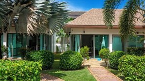 A modern building with a tiled roof and large glass windows. - Naya Poly Pool Villa-80 (Phuket)
