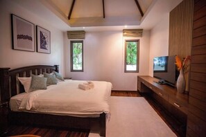 A bedroom with a bed, a television, and a window. - Naya Poly Pool Villa-80 (Phuket)