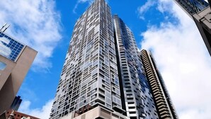A tall, modern skyscraper with a grid-like facade and multiple balconies. - A Chic 2BR, CBD Apartment Near Southern Cross (Melbourne)