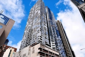A tall, modern skyscraper with a grid-like facade and multiple balconies. - A Chic 2BR, CBD Apartment Near Southern Cross (Melbourne)