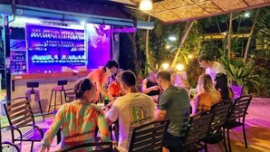 An outdoor bar area with seating and a bar counter. - patong beautiful pool villa (Phuket)