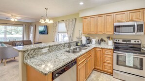 A kitchen with granite countertops, stainless steel appliances, wooden cabinets, and a dishwasher. - Steps to Pool + Golf! Family Myrtle Beach Retreat (Myrtle Beach)