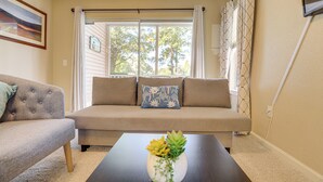 A living room with a beige sofa, a smaller armchair, and a coffee table with a plant. - Steps to Pool + Golf! Family Myrtle Beach Retreat (Myrtle Beach)