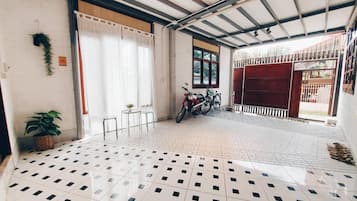 A clean, tiled floor with a bicycle parked inside a building.