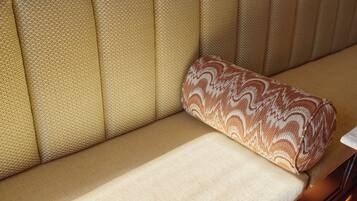 A sofa with a patterned cushion.