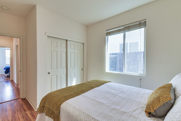 A bedroom with a bed, a window, and a door. - 7 Mi to Lake Yosemite: Family Home w/ Fenced Yard (Merced)