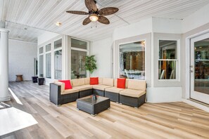 A spacious living area with a sectional sofa, a coffee table, and a ceiling fan. - Theater Room + Gazebo: Luxury Retreat in Ellenwood (Ellenwood)