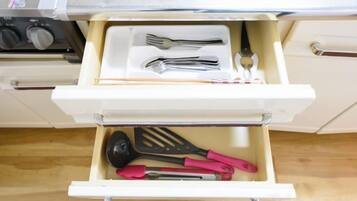 A kitchen drawer with utensils.