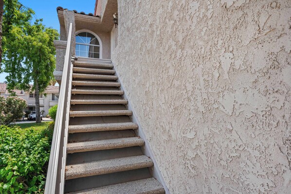 A stone staircase leading to a building with a textured wall and a window. - The Preserve at Mesquite For 4 (Palm Springs)
