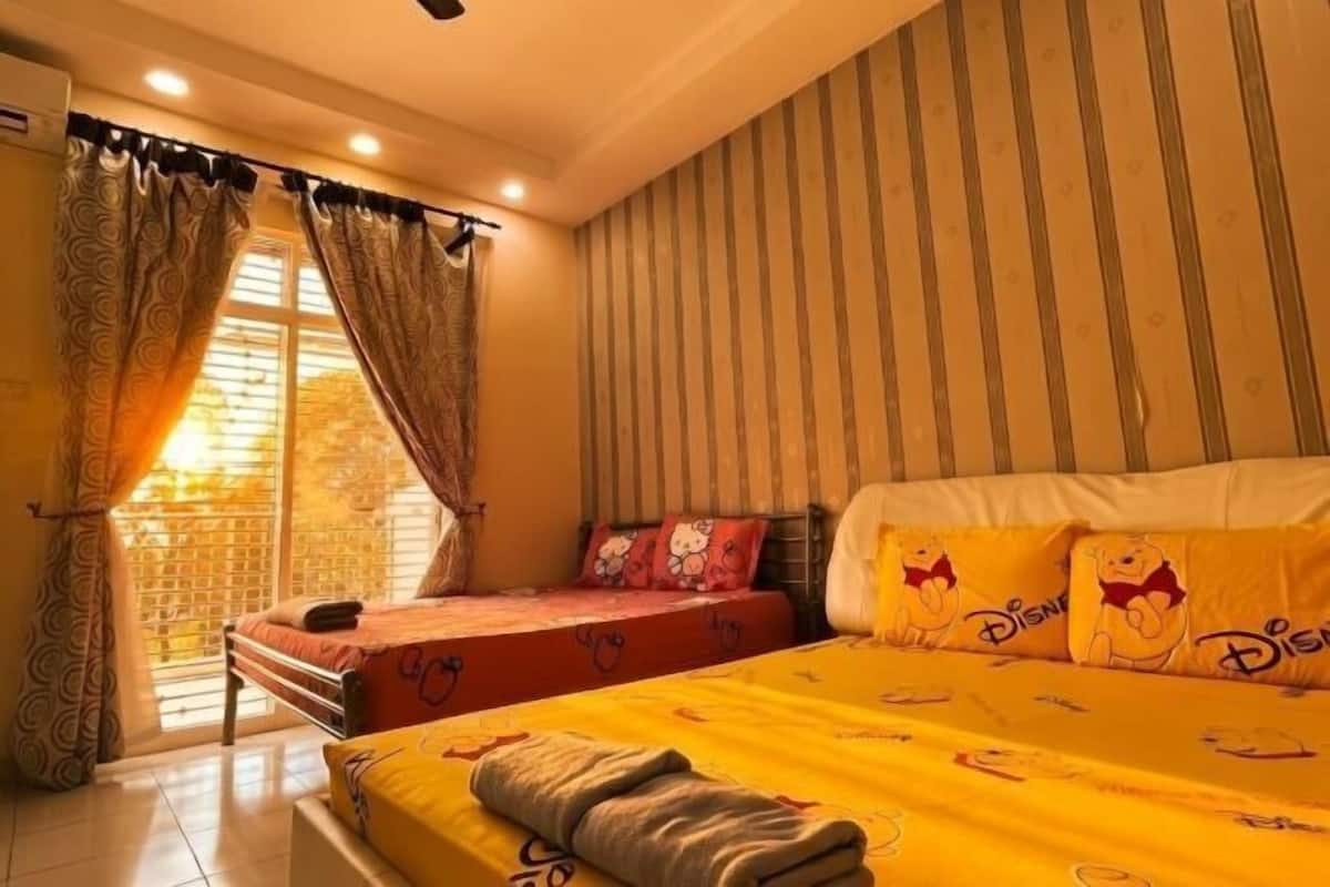 A hotel room with a bed, a smaller bed, curtains, a window, and a striped wall.