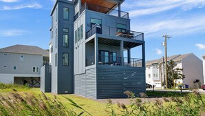 A modern two-story building with balconies and large windows.