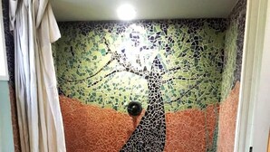 A bathroom with a mosaic wall, a toilet, and a shower area. - Pet Friendly Breathtaking Cottage with Hot-tub in Rainbow, California (Fallbrook)