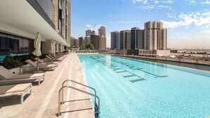 A swimming pool with a cityscape in the background.