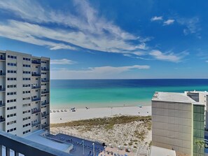 A high-rise building with a view of a beach and ocean. - Pinnacle Port #A-933 | Gulf and Bay Views + Amenities (Panama City Beach)