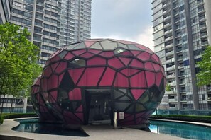 A spherical building with a geometric facade, surrounded by high-rise residential buildings. - ARTE@AMPANG (Ampang)