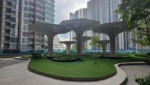 A modern urban park with geometric structures, surrounded by high-rise buildings. - ARTE@AMPANG (Ampang)