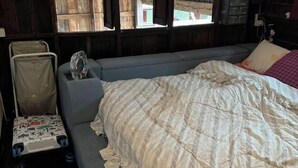 A small, cozy room with a single bed, a chair, and a small table. - BanGoDangtia (Pak Chong)