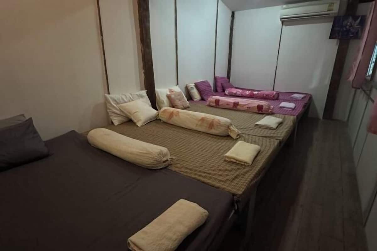 A room with a bed, a sofa, and a small table.