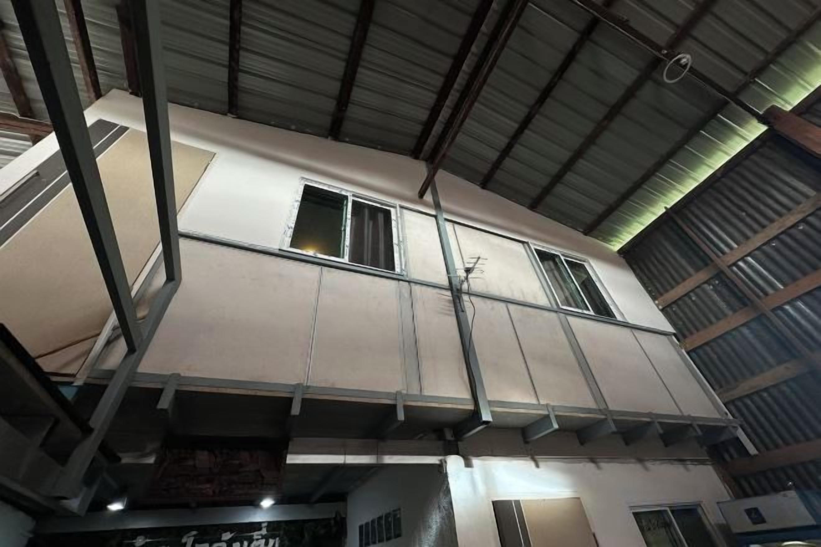 A multi-level building with a metal roof and several windows.