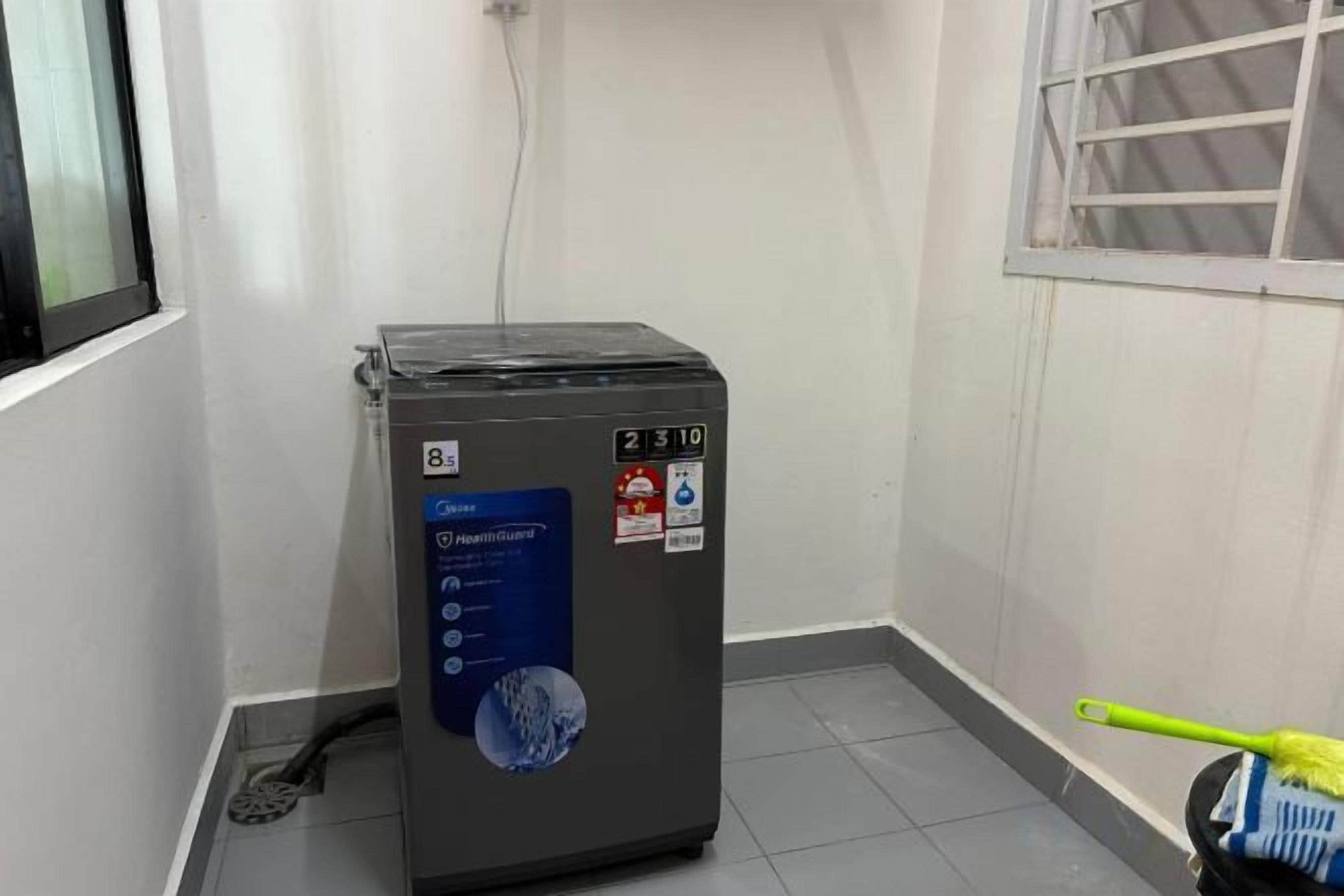 A compact, grey portable heater with a digital display and a blue label indicating it is a 'HeatPump' model.