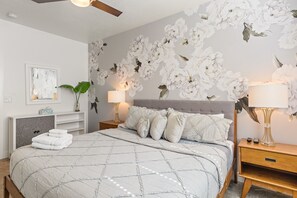 A bedroom with a bed, nightstands, a desk, and a ceiling fan. - Grand Coral Estate 6 Bedroom Townhouse (Washington)