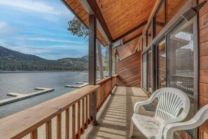 A wooden deck with a view of a lake and mountains. - 254 Bldg D 2 Bedroom Townhouse (Truckee)