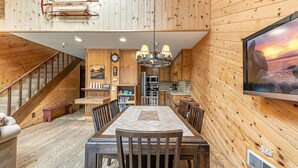 A wooden interior with a dining area, kitchen, and staircase. - 254 Bldg D 2 Bedroom Townhouse (Truckee)