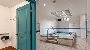 Un bagno moderno con una porta color verde acqua, un asciugatore automatico e un pavimento piastrellato.