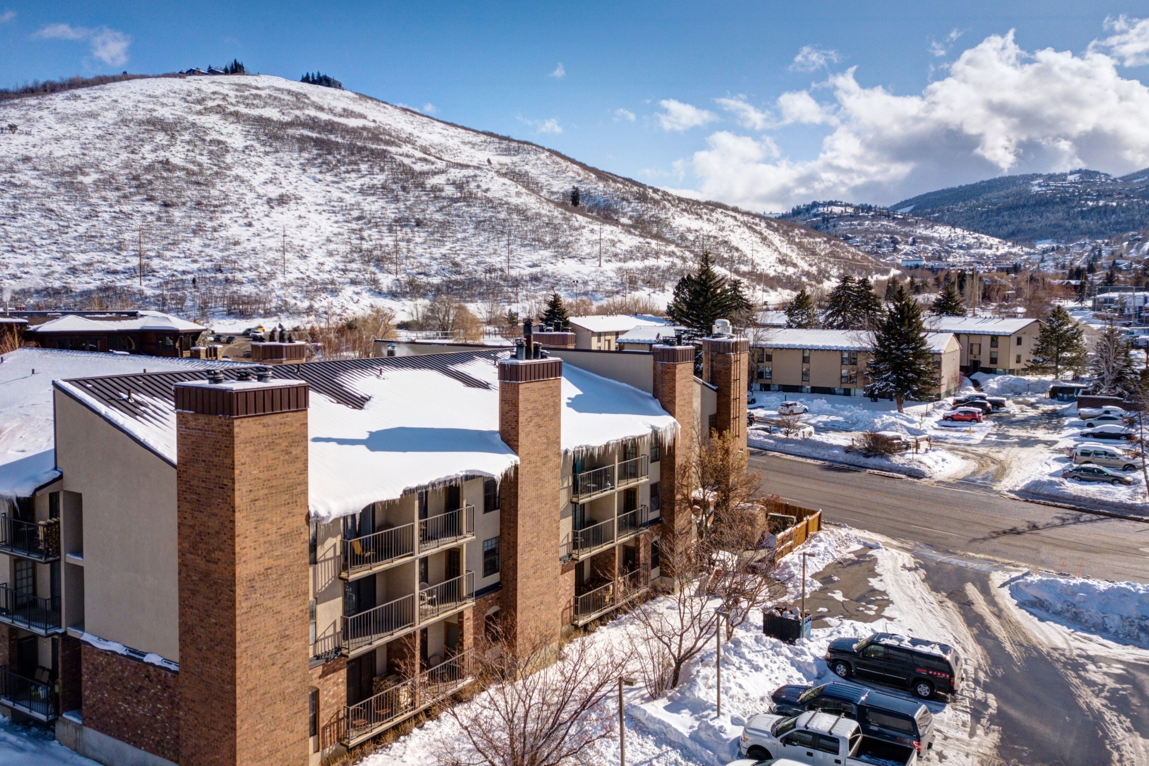 A multi-story building with a snow-covered roof and brick exterior.