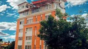 A multi-story building with a brick facade and a flat roof. - Deepjyoti Inn (Kathmandu)