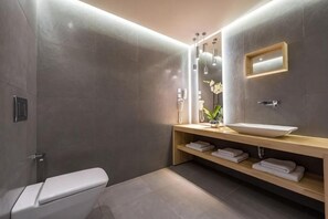 A modern bathroom with a toilet, sink, and shower area. - Arkadia Hotel (Arkadii)